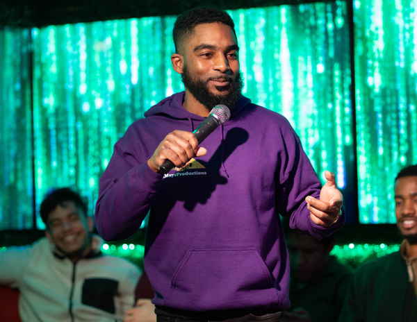 Picture of our male blue comedy comedian midway through giving standup comedy performance at private party | Altus Entertainment